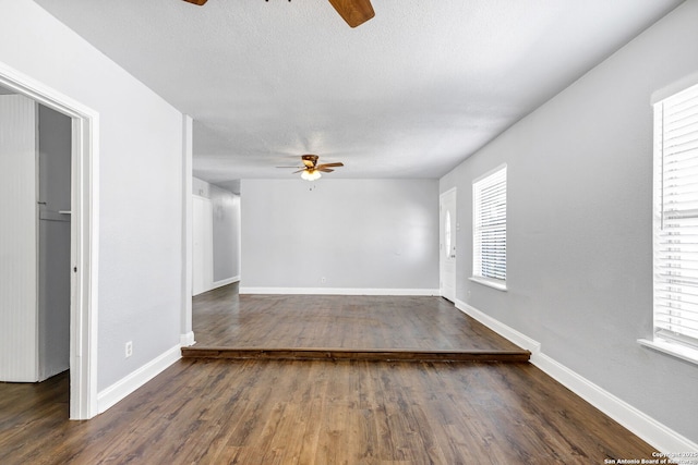 spare room featuring ceiling fan, a textured ceiling, baseboards, and wood finished floors