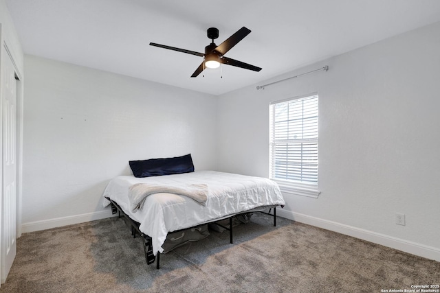 bedroom with ceiling fan, baseboards, and carpet flooring