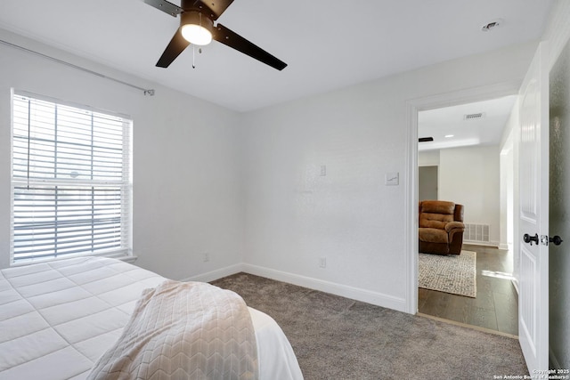 bedroom featuring ceiling fan, carpet flooring, visible vents, and baseboards