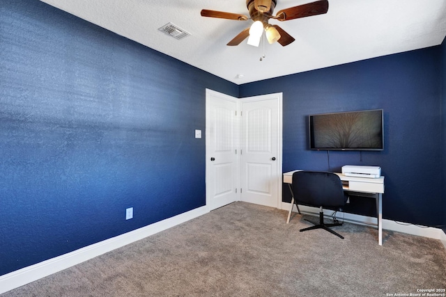 unfurnished office with baseboards, visible vents, ceiling fan, and carpet flooring