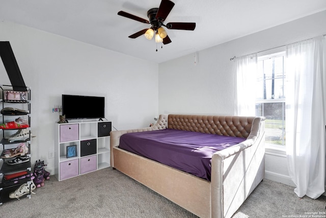 carpeted bedroom with a ceiling fan and multiple windows