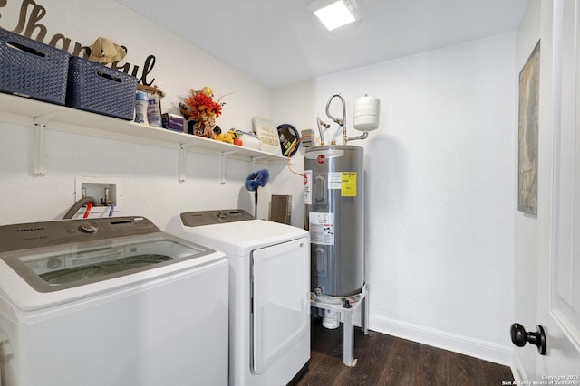 washroom with electric water heater, laundry area, dark wood-style flooring, baseboards, and washer and dryer