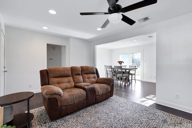 living area featuring recessed lighting, visible vents, baseboards, and wood finished floors