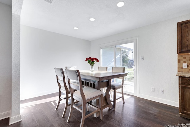 dining space featuring dark wood-type flooring, recessed lighting, and baseboards