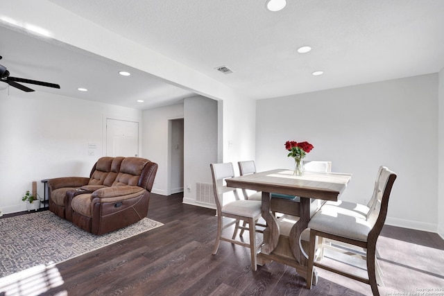 dining room with baseboards, wood finished floors, and recessed lighting