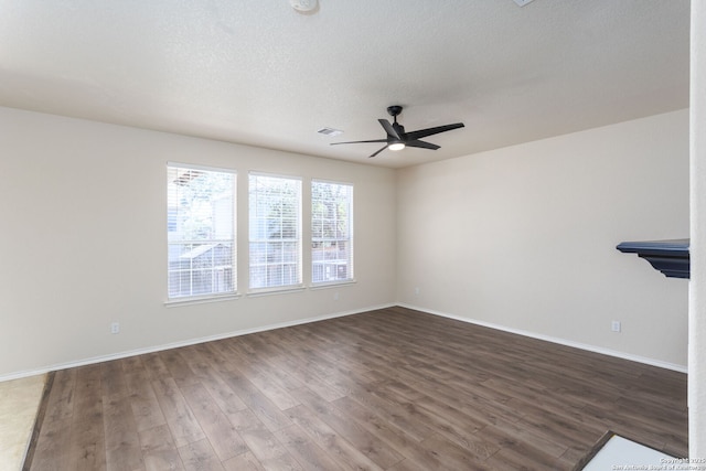 unfurnished living room with baseboards, visible vents, ceiling fan, wood finished floors, and a textured ceiling