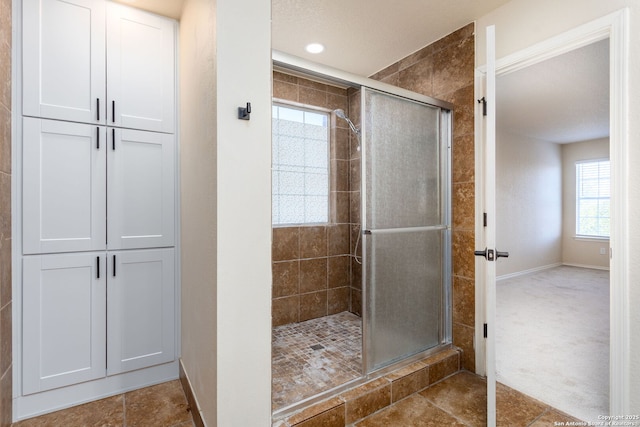 full bathroom with a stall shower, recessed lighting, and baseboards