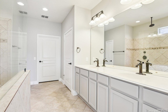 full bathroom featuring visible vents, a walk in shower, and a sink