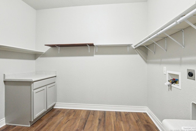 laundry room with baseboards, dark wood-type flooring, and hookup for an electric dryer