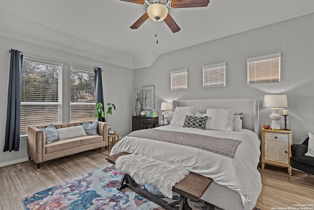 bedroom featuring a ceiling fan, baseboards, and wood finished floors