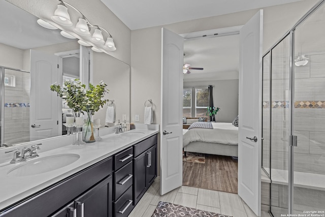 bathroom with connected bathroom, a stall shower, a sink, and double vanity