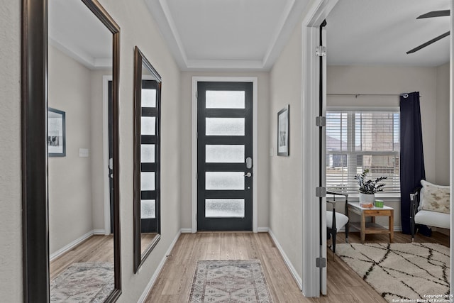 foyer with ceiling fan, light wood-type flooring, and baseboards