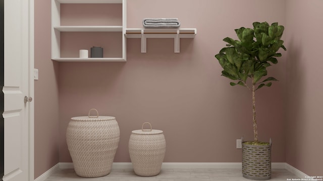 mudroom featuring baseboards and wood finished floors