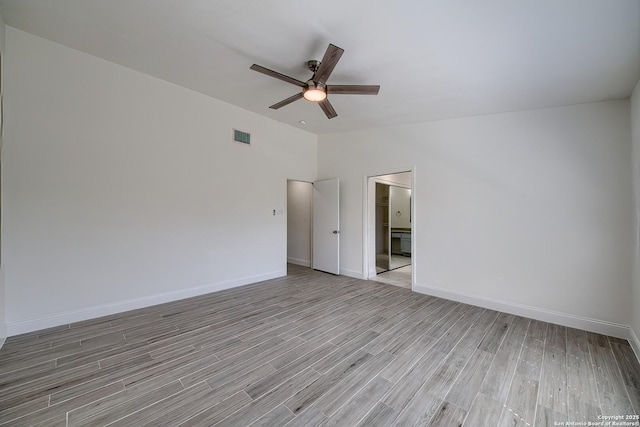 unfurnished room with visible vents, baseboards, lofted ceiling, ceiling fan, and light wood-type flooring