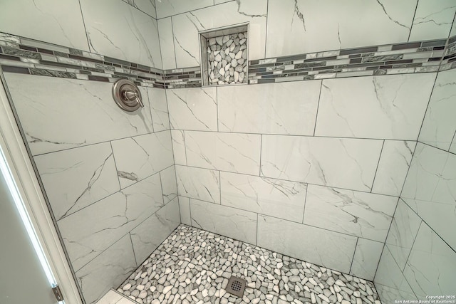 bathroom with a tile shower