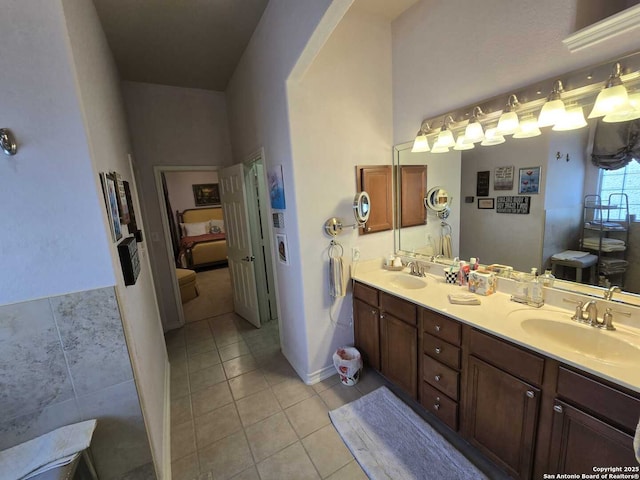 bathroom with double vanity, a sink, and tile patterned floors