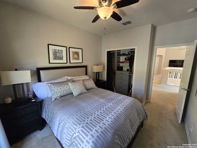 bedroom featuring light carpet, ceiling fan, a closet, and visible vents