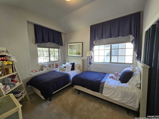 bedroom featuring vaulted ceiling and carpet flooring