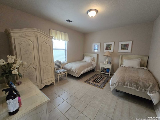 bedroom with visible vents and light tile patterned flooring