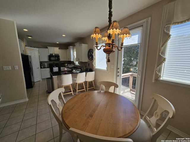 dining room with recessed lighting, light tile patterned flooring, baseboards, and an inviting chandelier