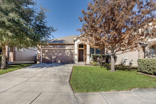 view of front facade featuring brick siding, a front yard, a garage, stone siding, and driveway