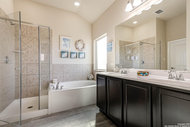 bathroom featuring a stall shower, a sink, and visible vents