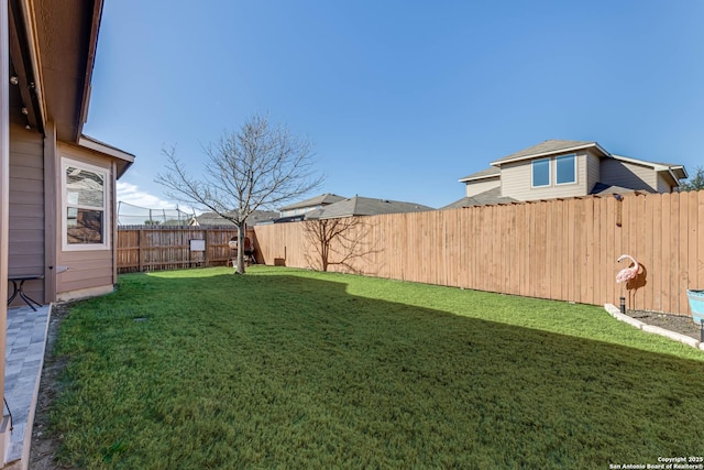 view of yard with a fenced backyard