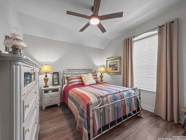 bedroom with a ceiling fan, vaulted ceiling, baseboards, and wood finished floors