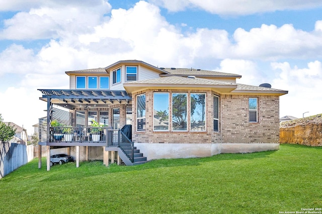 back of property featuring a yard, fence, and brick siding