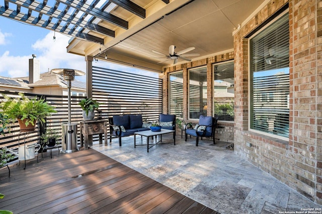 wooden terrace with an outdoor hangout area, a ceiling fan, and a pergola