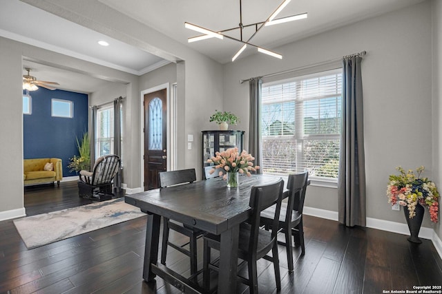 dining area featuring baseboards, dark wood finished floors, an inviting chandelier, crown molding, and recessed lighting