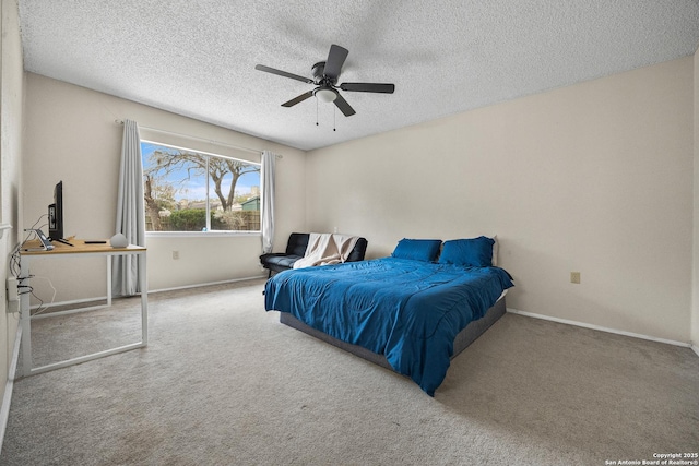 bedroom with carpet, baseboards, and a textured ceiling