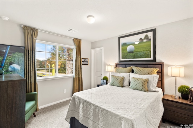 carpeted bedroom featuring baseboards and visible vents