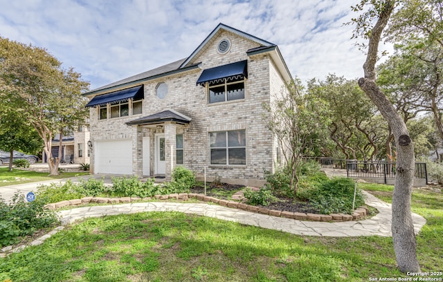 view of front facade featuring a front lawn, concrete driveway, brick siding, and an attached garage