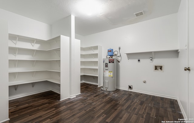 clothes washing area with washer hookup, hookup for a gas dryer, water heater, visible vents, and electric dryer hookup