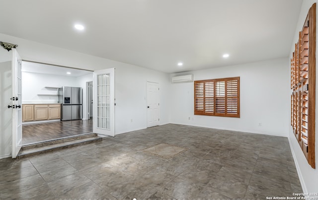 empty room featuring recessed lighting, baseboards, and a wall mounted AC