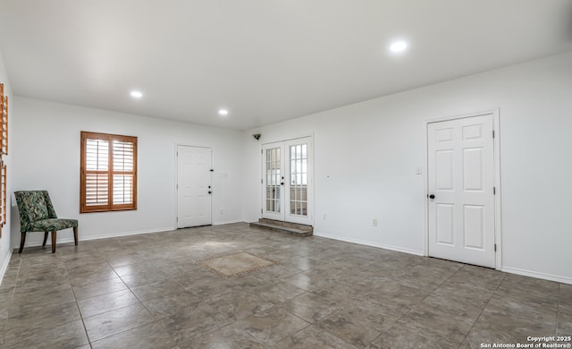 foyer entrance with french doors, recessed lighting, and baseboards