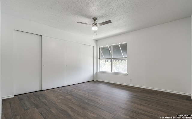 unfurnished bedroom with baseboards, ceiling fan, wood finished floors, a textured ceiling, and a closet