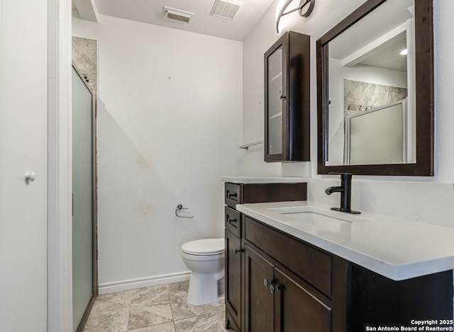 bathroom featuring toilet, a shower stall, and visible vents