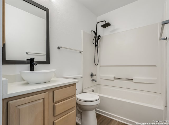 full bathroom featuring shower / bath combination, vanity, toilet, and wood finished floors