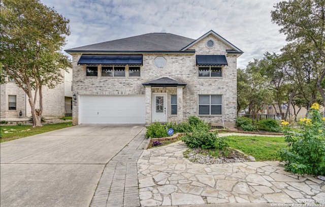 view of front of home with a garage, driveway, and brick siding