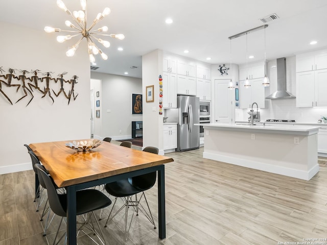 dining space with light wood-type flooring, baseboards, visible vents, and recessed lighting