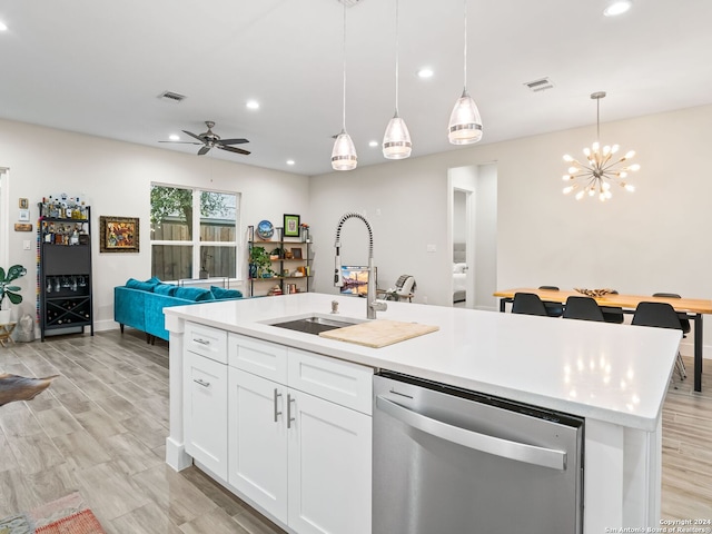 kitchen with a kitchen island with sink, a sink, visible vents, light countertops, and stainless steel dishwasher