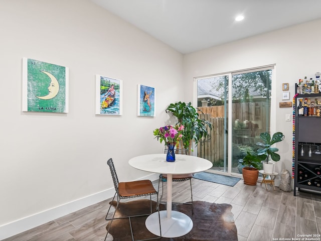 dining space with wood tiled floor, baseboards, and recessed lighting