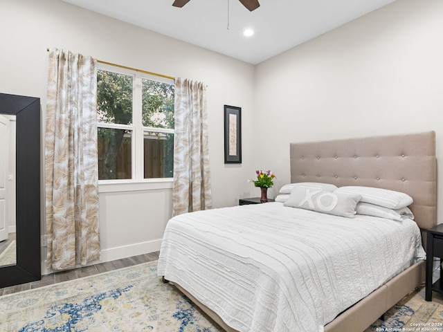 bedroom featuring a ceiling fan, baseboards, wood finished floors, and recessed lighting