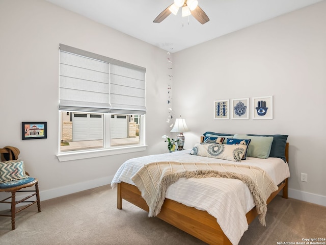 carpeted bedroom with a ceiling fan and baseboards