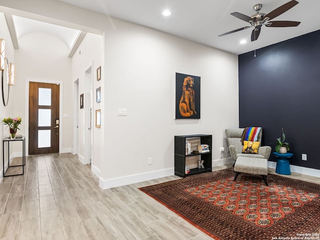 living area with light wood finished floors, ceiling fan, baseboards, and recessed lighting