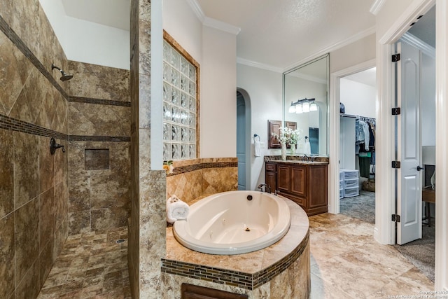 full bath featuring vanity, a spacious closet, tiled shower, a whirlpool tub, and crown molding