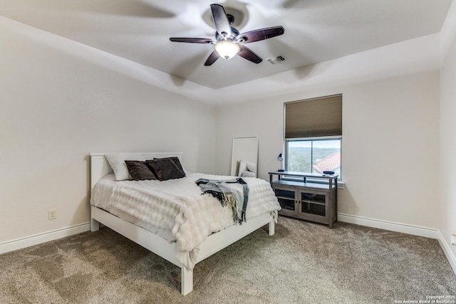 carpeted bedroom featuring ceiling fan, visible vents, and baseboards