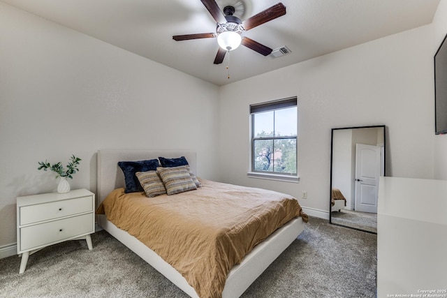 carpeted bedroom featuring baseboards, visible vents, and a ceiling fan